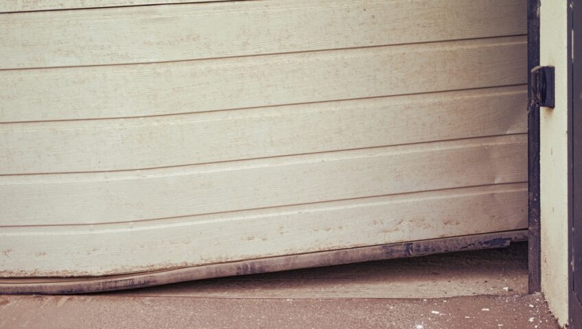 a damaged, bent garage door